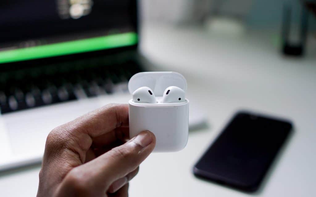 person holding airpods